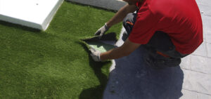 placing artificial grass on surface